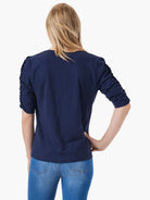 Here's alt text for the image, suitable for visually impaired users:

"Rear view of a navy blue, elbow-sleeve top with...