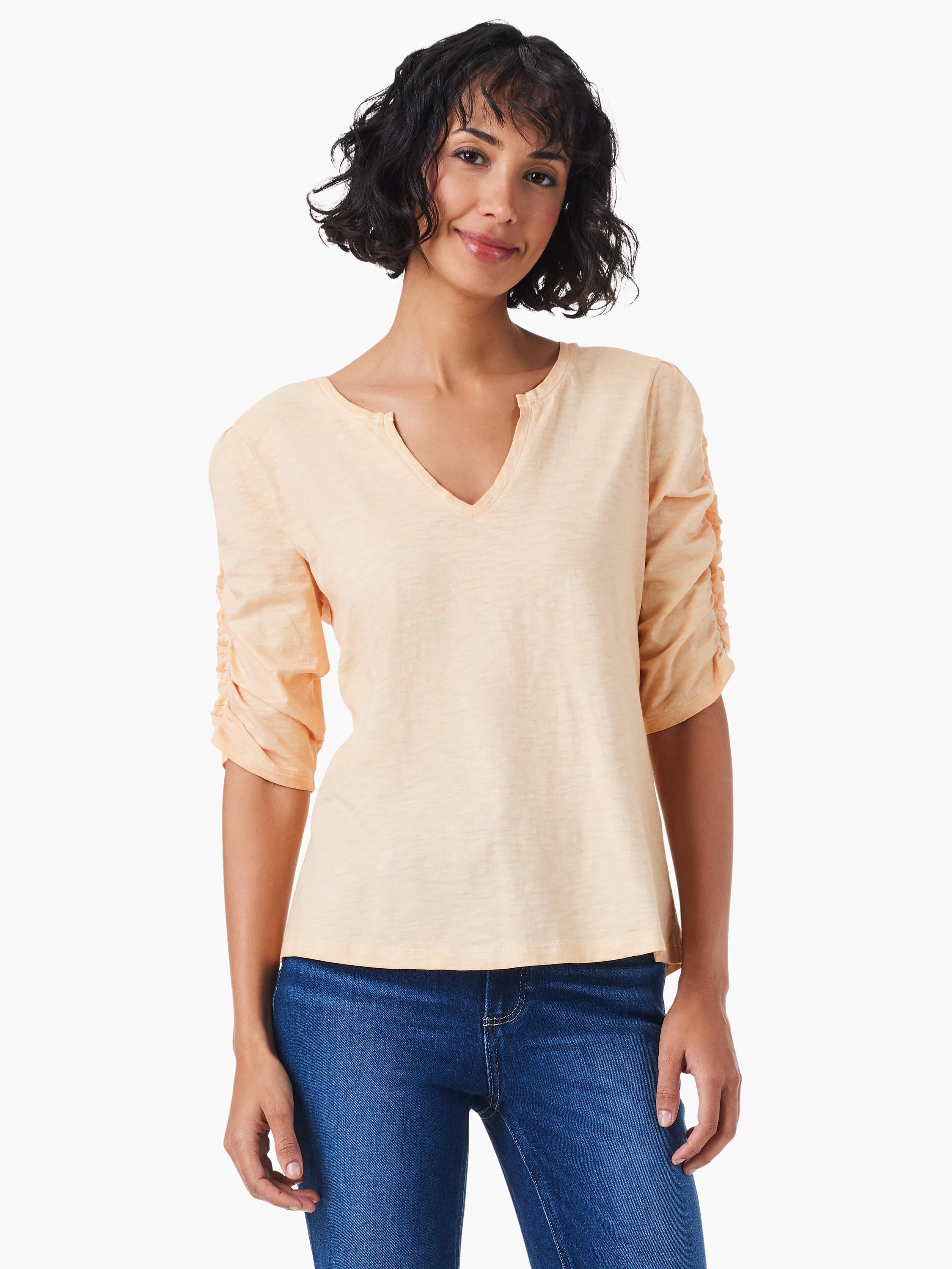Peach-colored, elbow-length ruched sleeves, split v-neck.