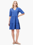 Blue tiered mini dress, V-neck, elbow-length sleeves.