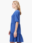 Blue tiered V-neck mini dress with elbow-length sleeves.