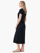 Black midi dress, short sleeves, side slits, cinched waist.  Shown on a model.