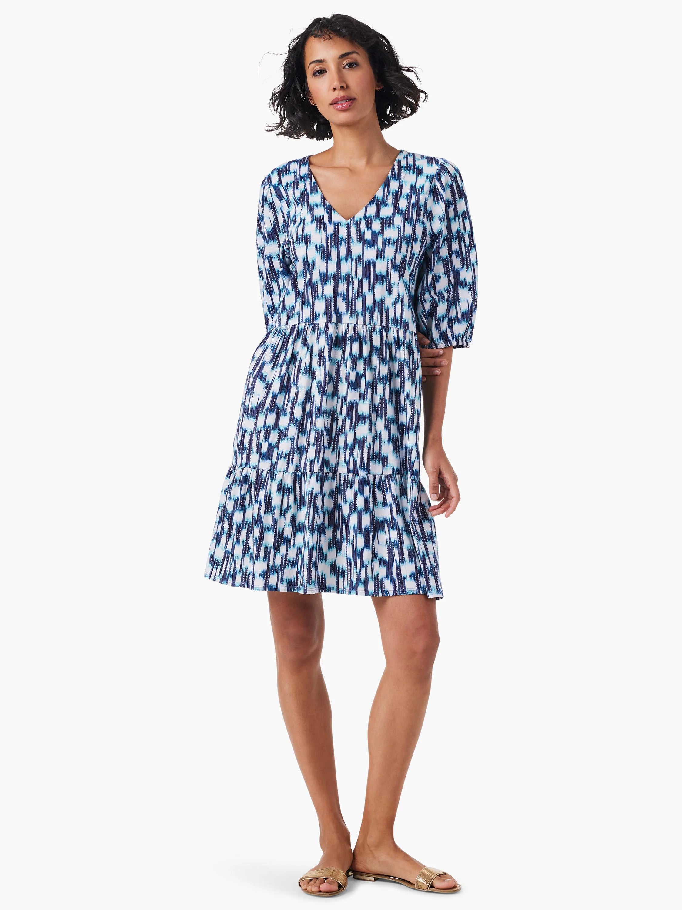 Tiered V-neck mini dress in blue, white, and dark teal abstract print.  Three-quarter sleeves.
