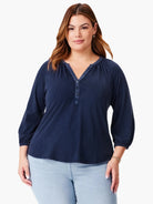 Navy blue 3/4 sleeve top with split neckline and three small buttons.  Slightly puffed sleeves.