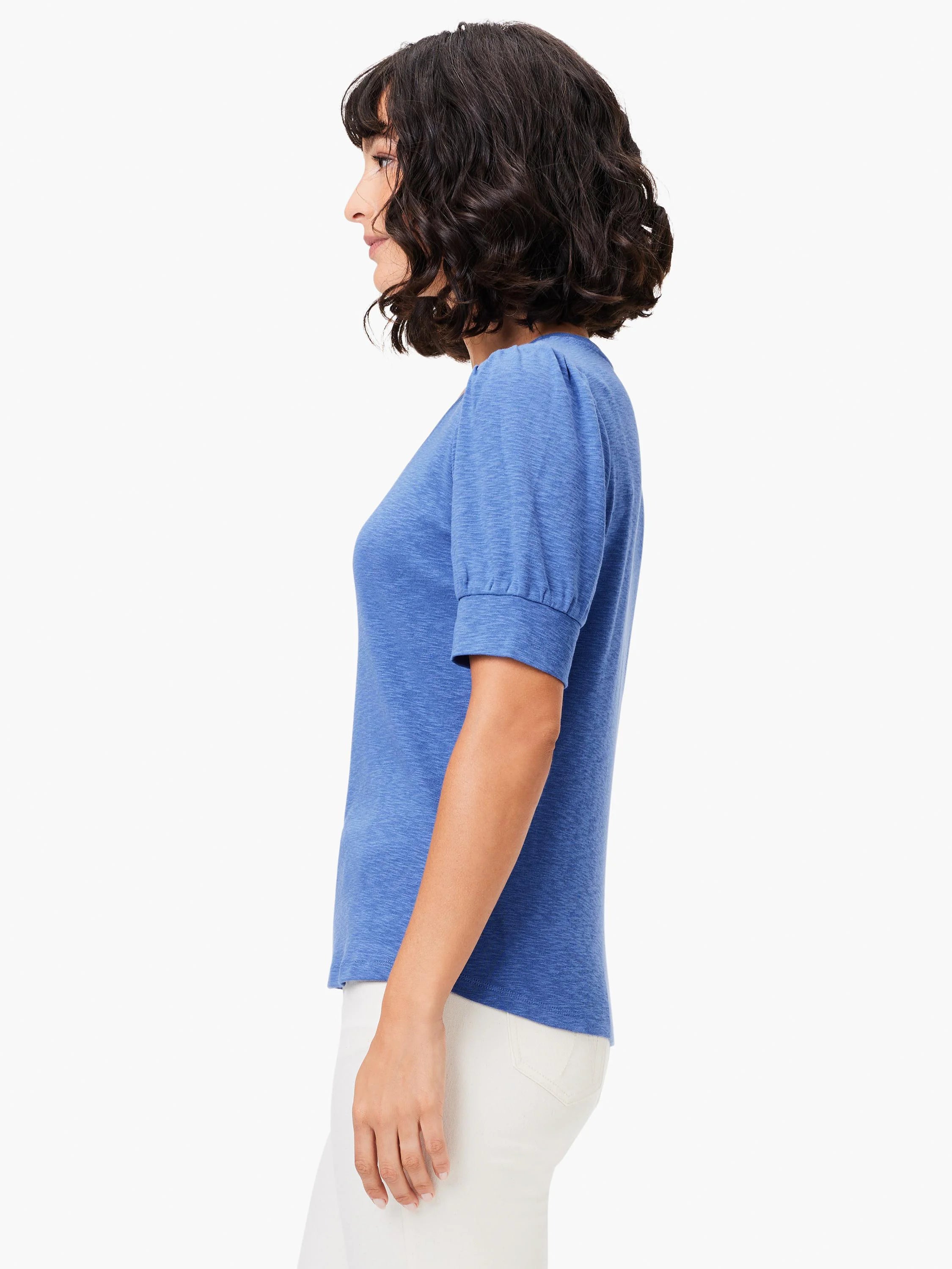 Blue scoop-neck tee with short, puffed sleeves.  Textured fabric. Side profile view.