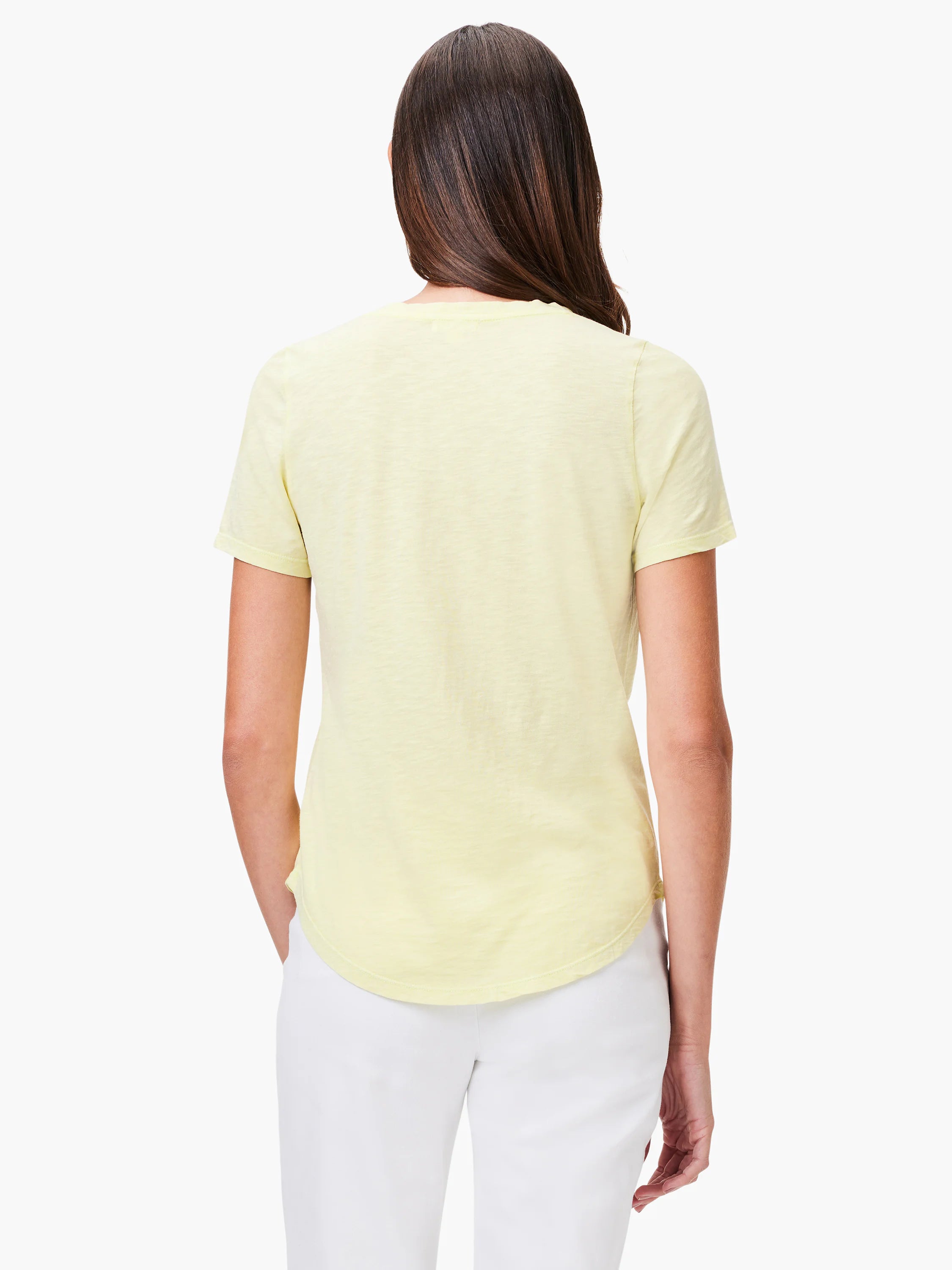 Pale yellow short-sleeve tee on a woman's back. Features textured fabric and rounded hem.