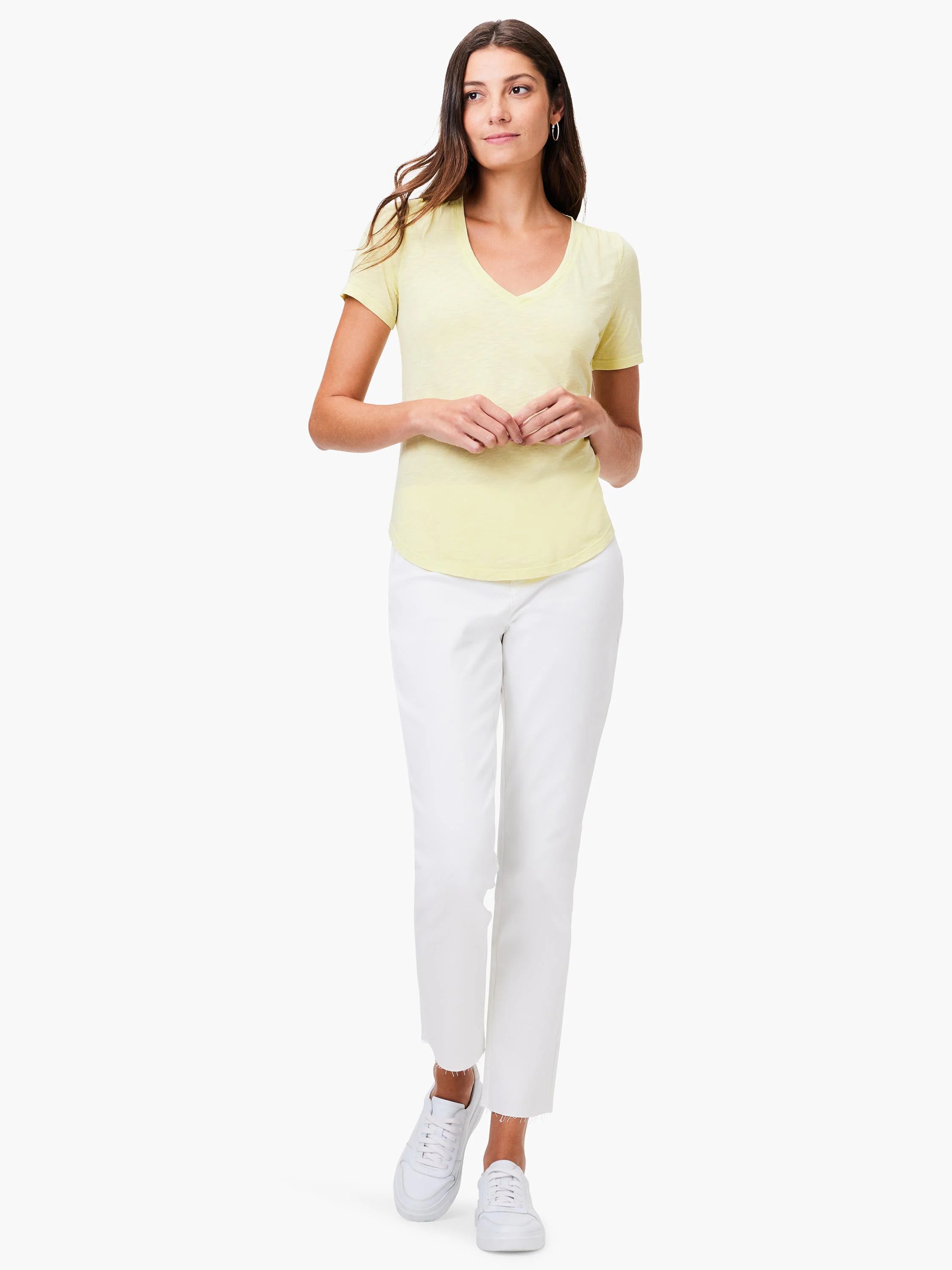 Pale yellow short-sleeve V-neck tee modeled by a woman, showing its relaxed fit and curved hemline.