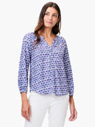 White shirt with blue and red medallion pattern, 3/4 sleeves, v-neck.