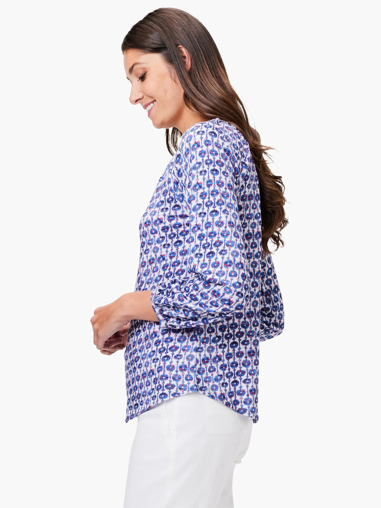 3/4 sleeve top; white background with blue, purple, and red medallion pattern.