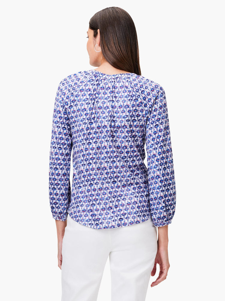 White top with blue and red medallion pattern. Three-quarter sleeves. Back view.