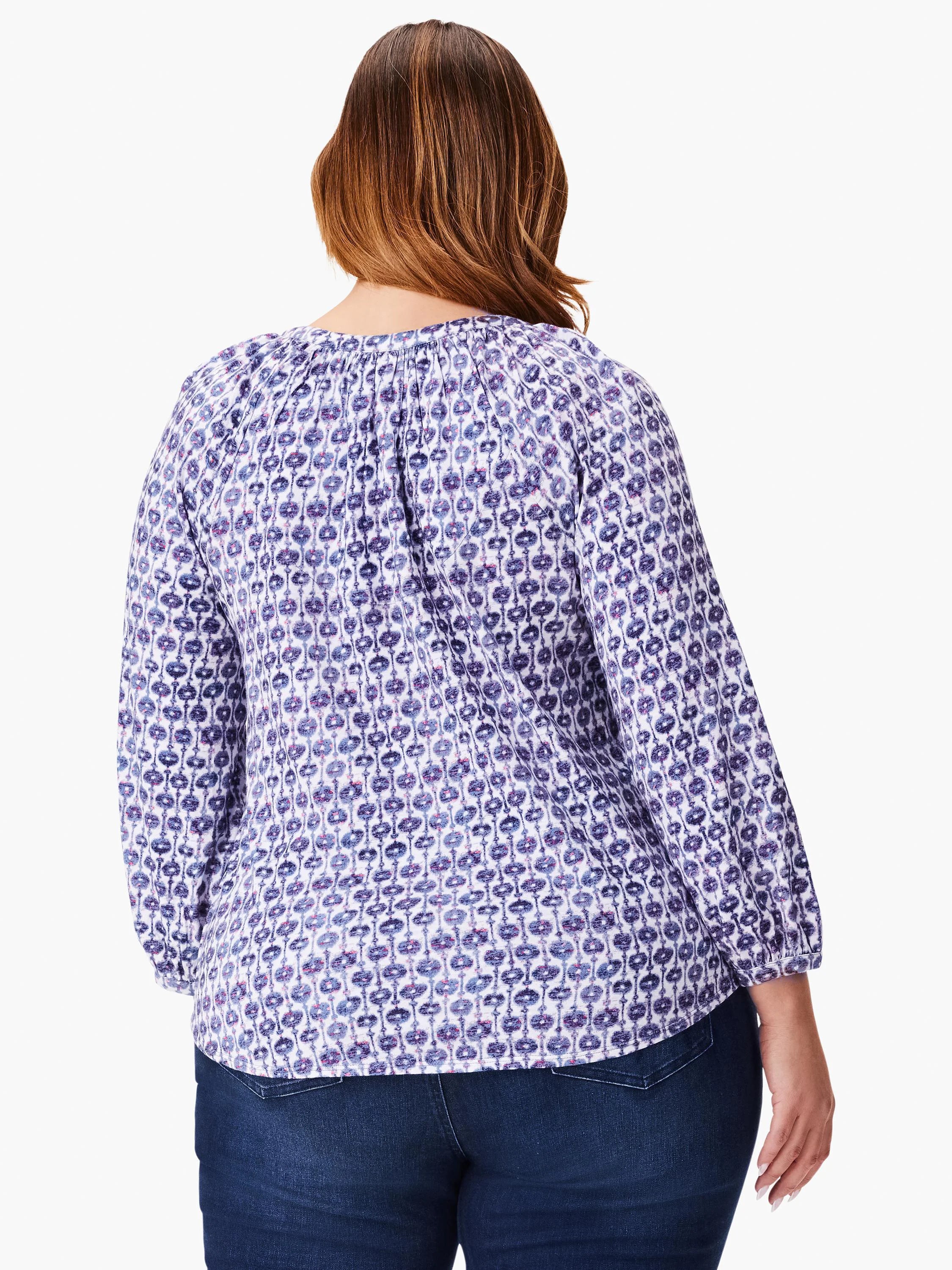 3/4 sleeve top, white background with purple and blue medallion pattern.  Split neckline.