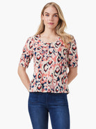 Pink, cream, and navy ikat pattern scoop-neck tee with elbow-length sleeves.