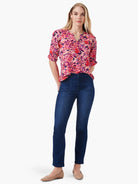 Pink floral elbow-sleeve top with ruched detail, V-neck.  Paired with dark wash jeans.