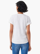 White off-white split neck tee, short sleeves with rolled cuffs.  Rear view.