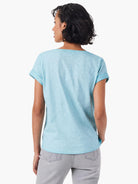 Back view of light blue, short-sleeved split neck tee.  Rolled cuffs.