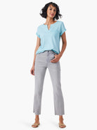 Light blue split-neck tee with a small pocket, shown with grey cropped jeans.