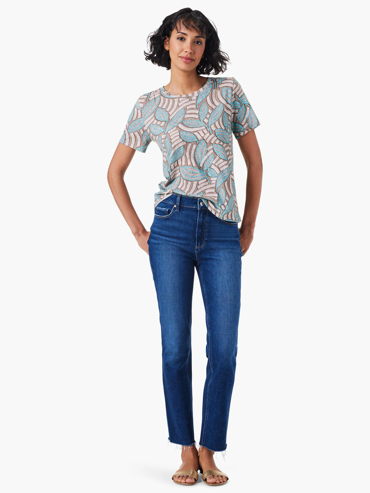 Short-sleeve crew neck tee with teal and brown leaf pattern on an off-white background.