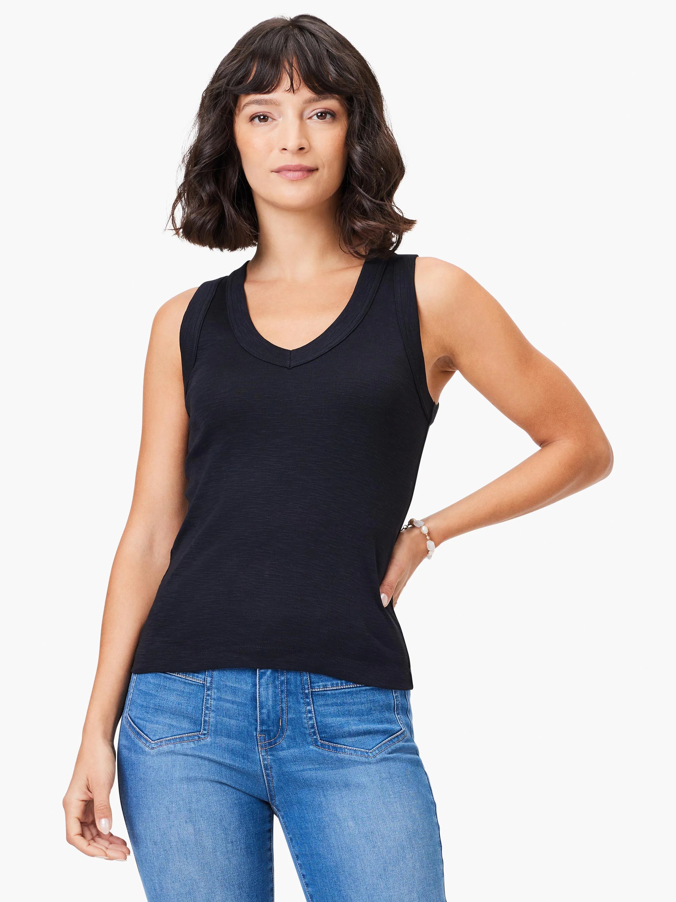 Black v-neck sleeveless shirt;  shows subtle texture.  Model wears light wash jeans.