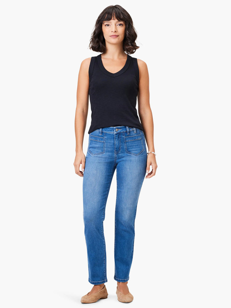 Black v-neck tank top and light blue jeans on a model.