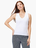 White V-neck sleeveless shirt.  Close-fitting, simple style.