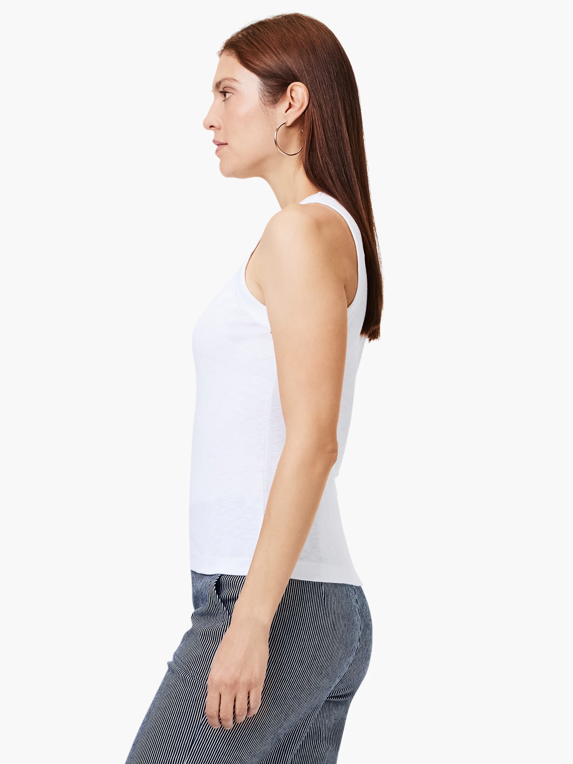 White v-neck tank top shown on model.  Side profile view.