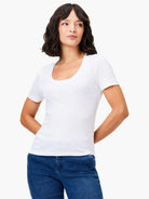 White scoop-neck short-sleeve tee.  Slightly textured fabric. Model wears with dark wash jeans.