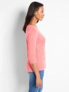 Salmon, heathered 3/4 sleeve boat neck tee shown on a woman, revealing its relaxed fit.