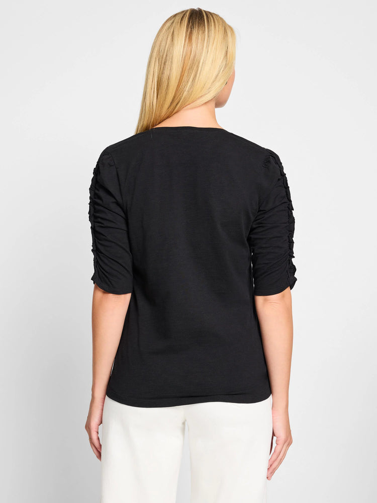 Black, elbow-sleeve t-shirt.  Ruched sleeves, split neckline.  Shown from the back.