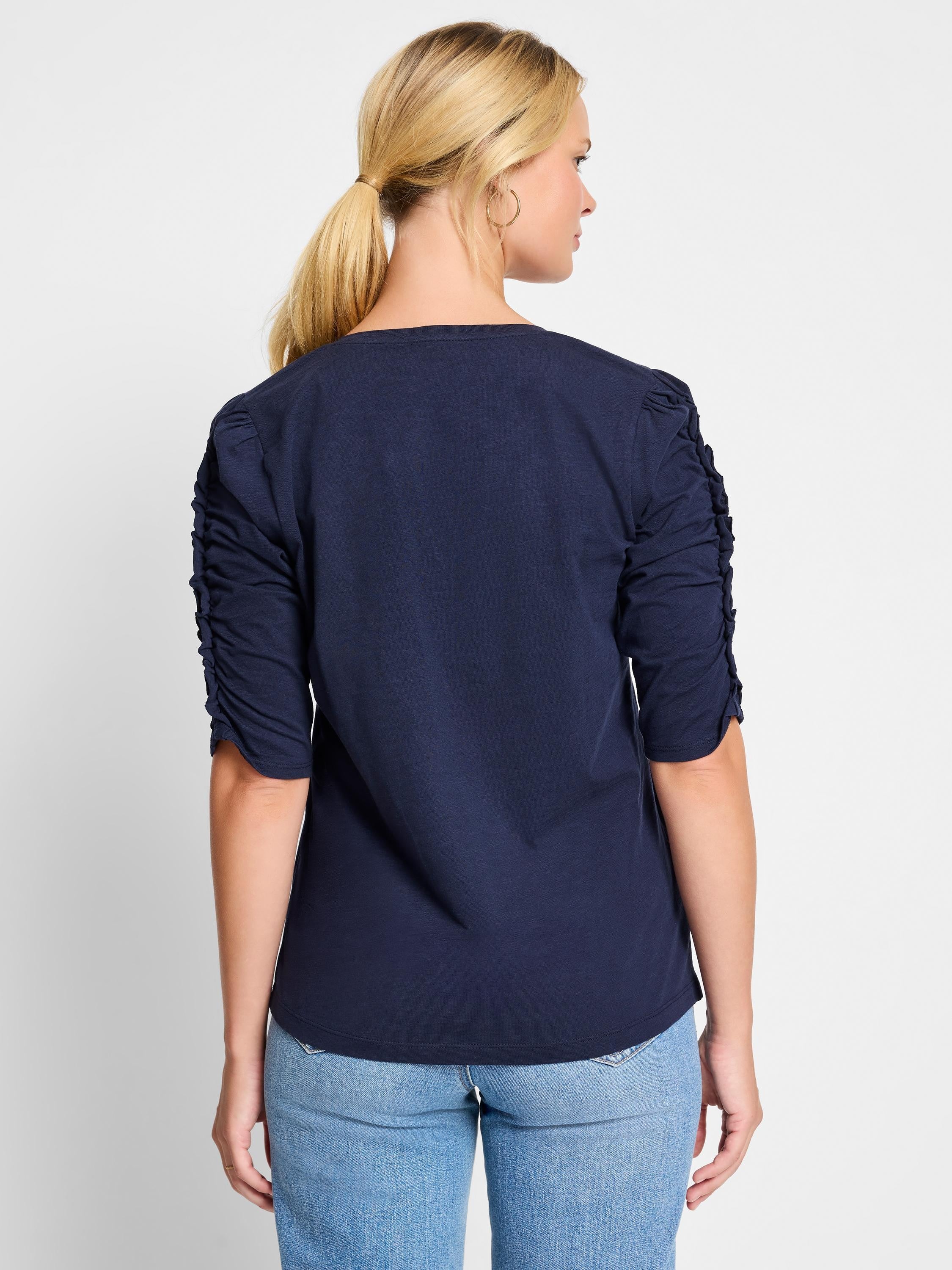 Here's alt text that describes the image concisely and accessibly:

Dark navy blue, elbow-sleeve t-shirt.  Ruched...