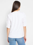 White elbow-sleeve t-shirt, ruched sleeves, split neckline.  Back view.