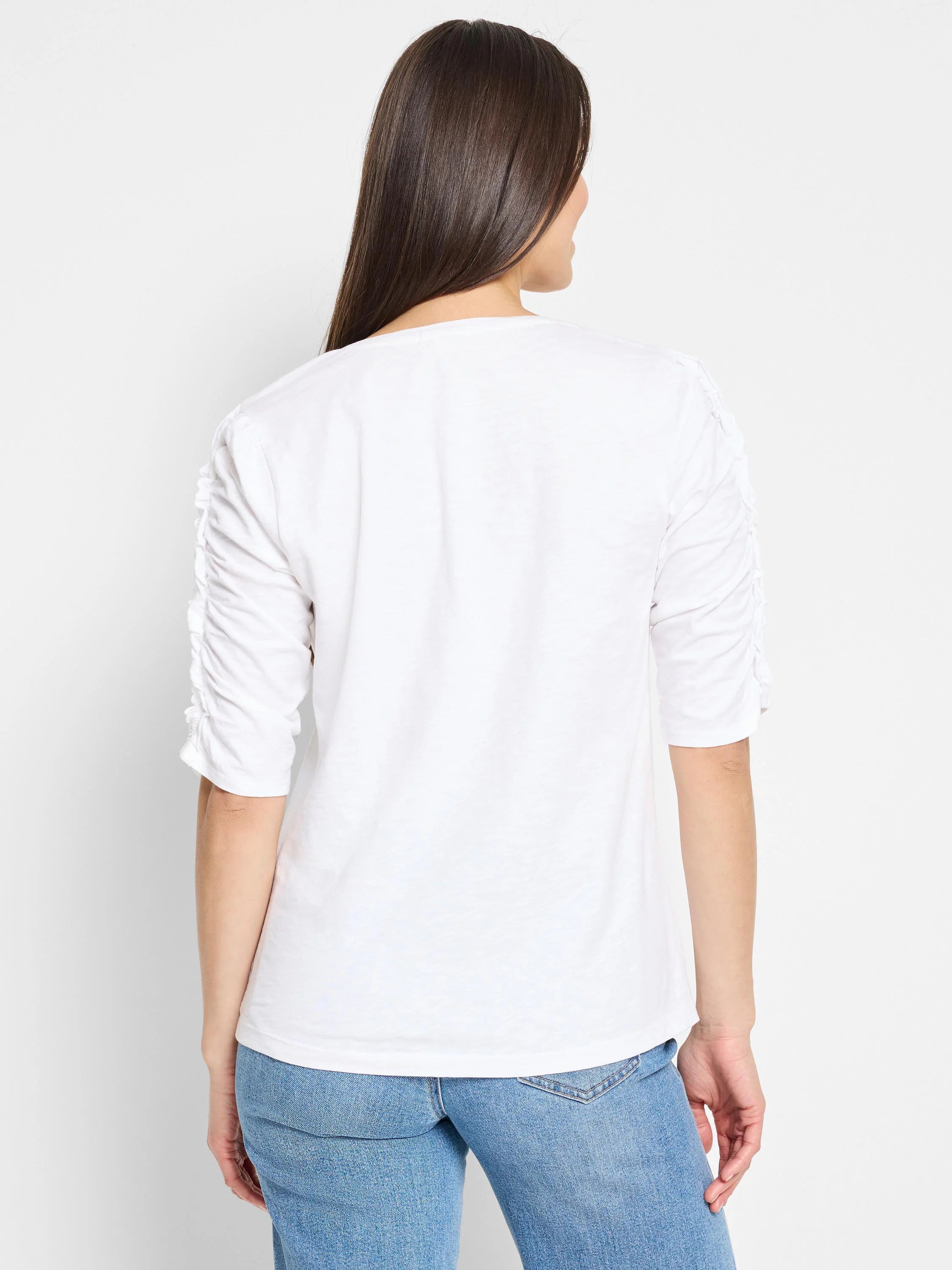 White elbow-sleeve t-shirt, ruched sleeves, split neckline.  Back view.