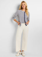 Cream and navy blue striped cardigan, snap front closure.  Long sleeves.