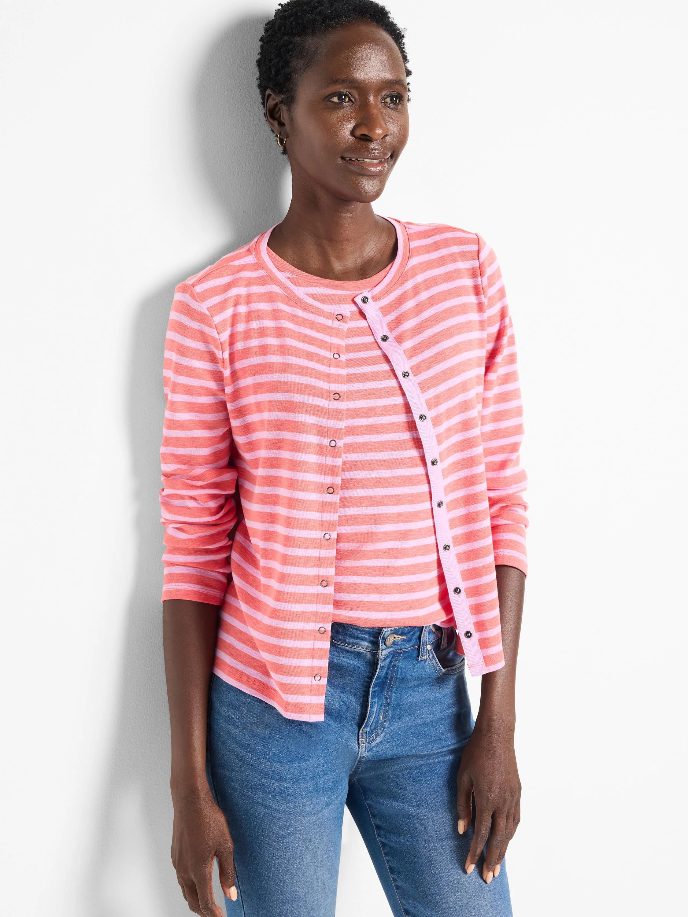 Pink and light pink striped cardigan, snap front closure, long sleeves.