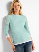 Light teal long-sleeve shirt, double layered with white trim at cuffs and hem.