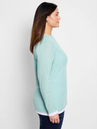 Light teal long-sleeve top, double layered with white underlayer.  Shown on model.