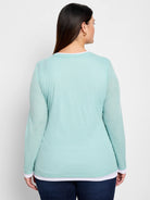 Back view of mint green long-sleeve shirt, double layered with white underlayer.