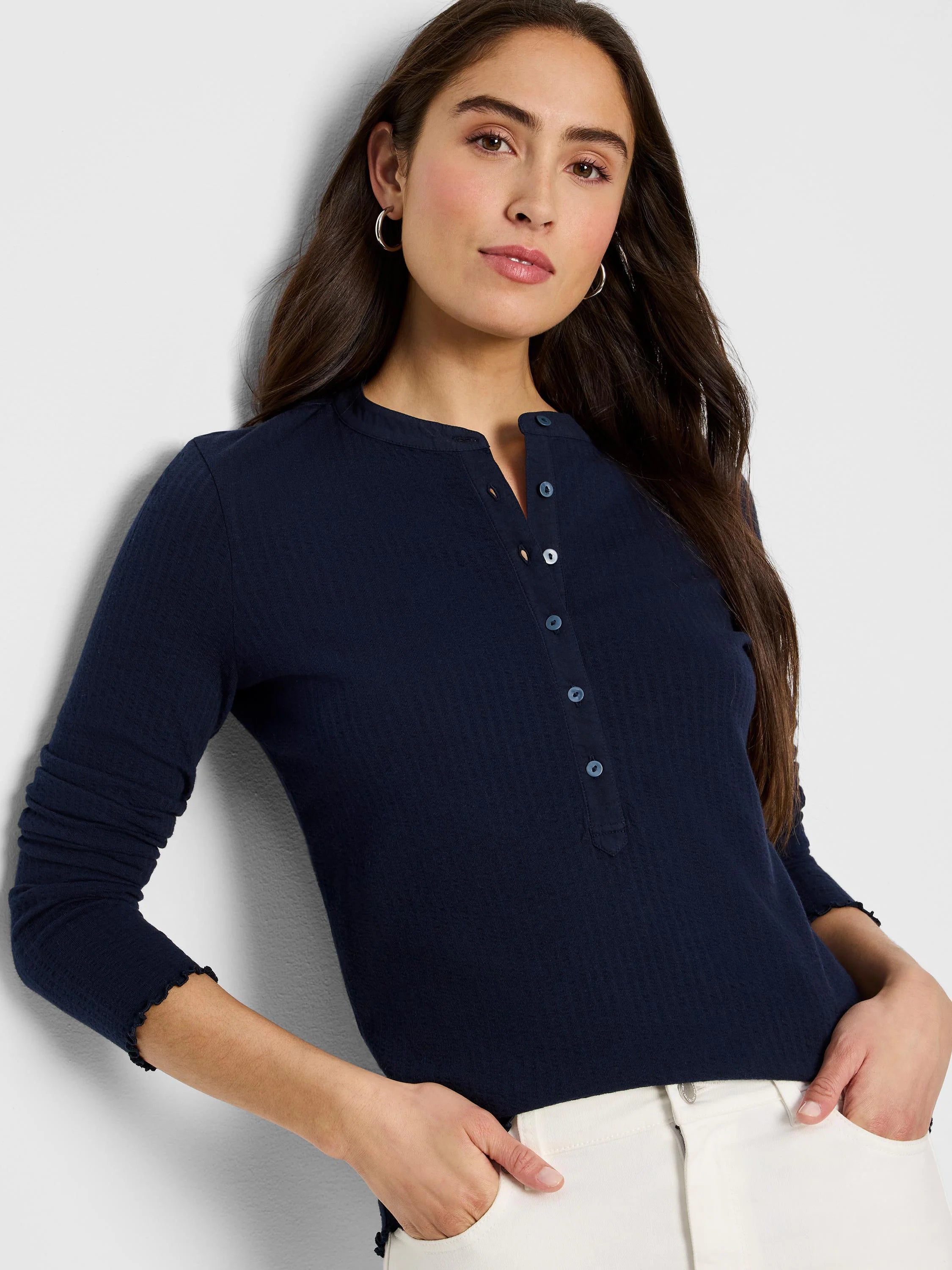 Navy blue ribbed long-sleeve henley shirt with dark buttons and scalloped cuffs.