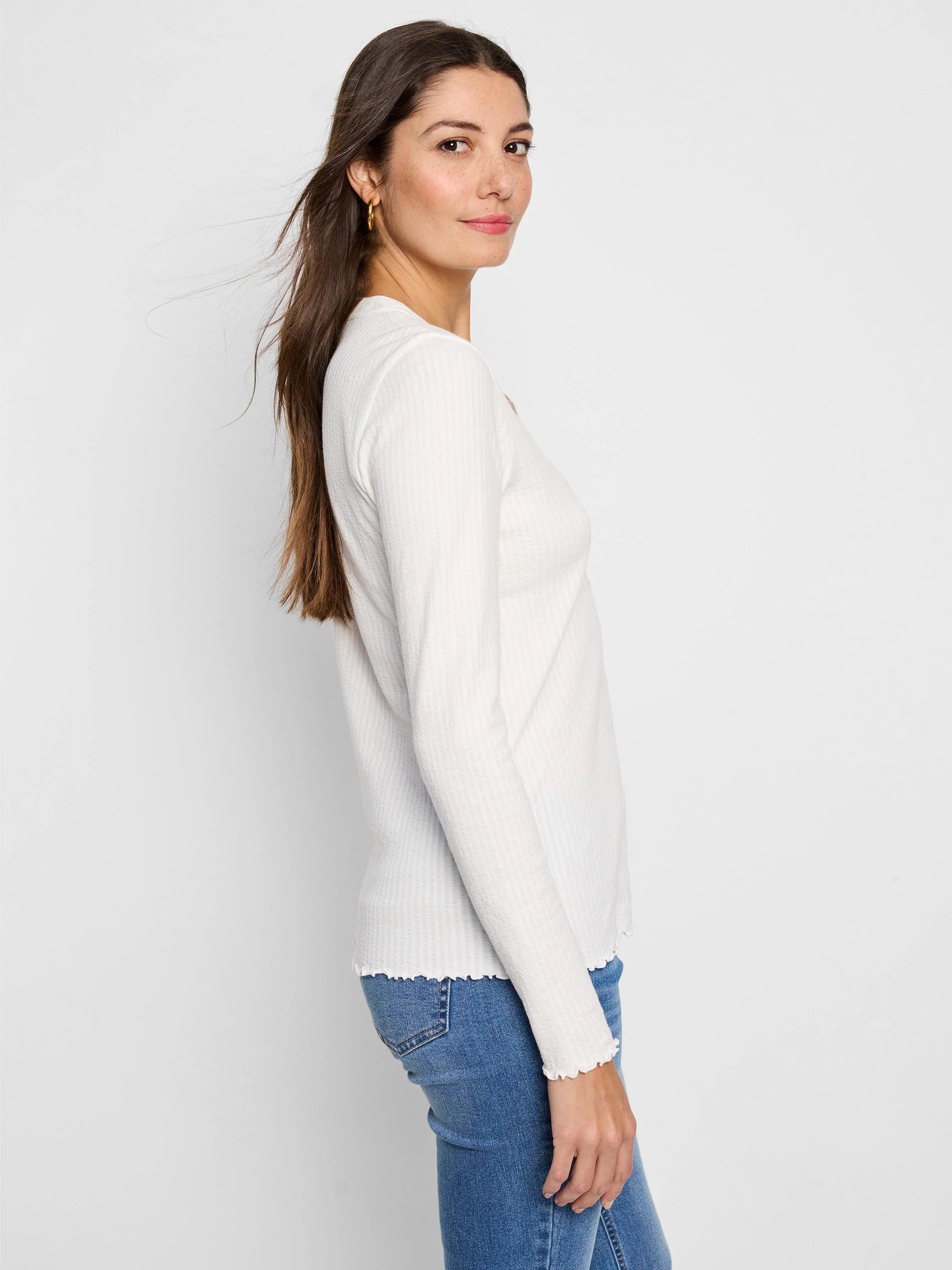 Off-white ribbed Henley shirt with long sleeves and scalloped hem.