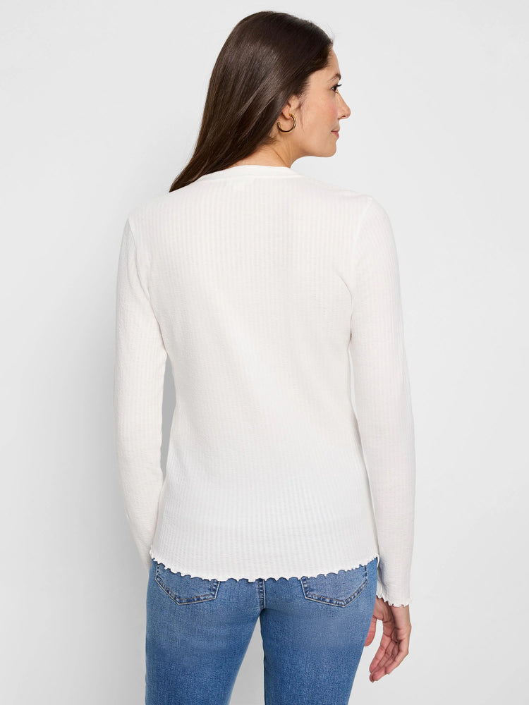 Off-white ribbed long-sleeve henley, scalloped hem and cuffs.  Rear view.