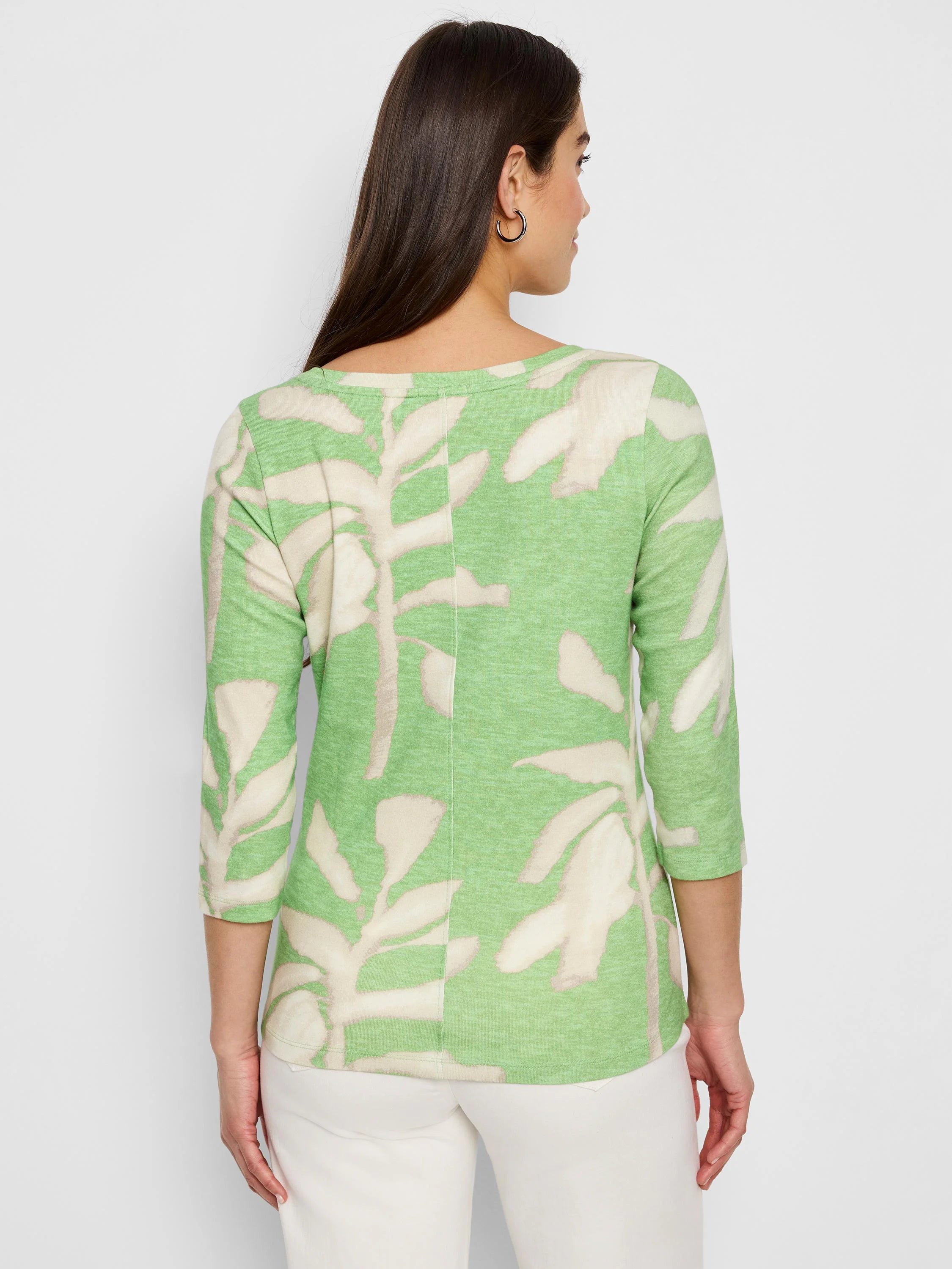 Here's alt text for the image, under 125 characters:

"Back view of light green 3/4 sleeve shirt.  Features a fern-like...