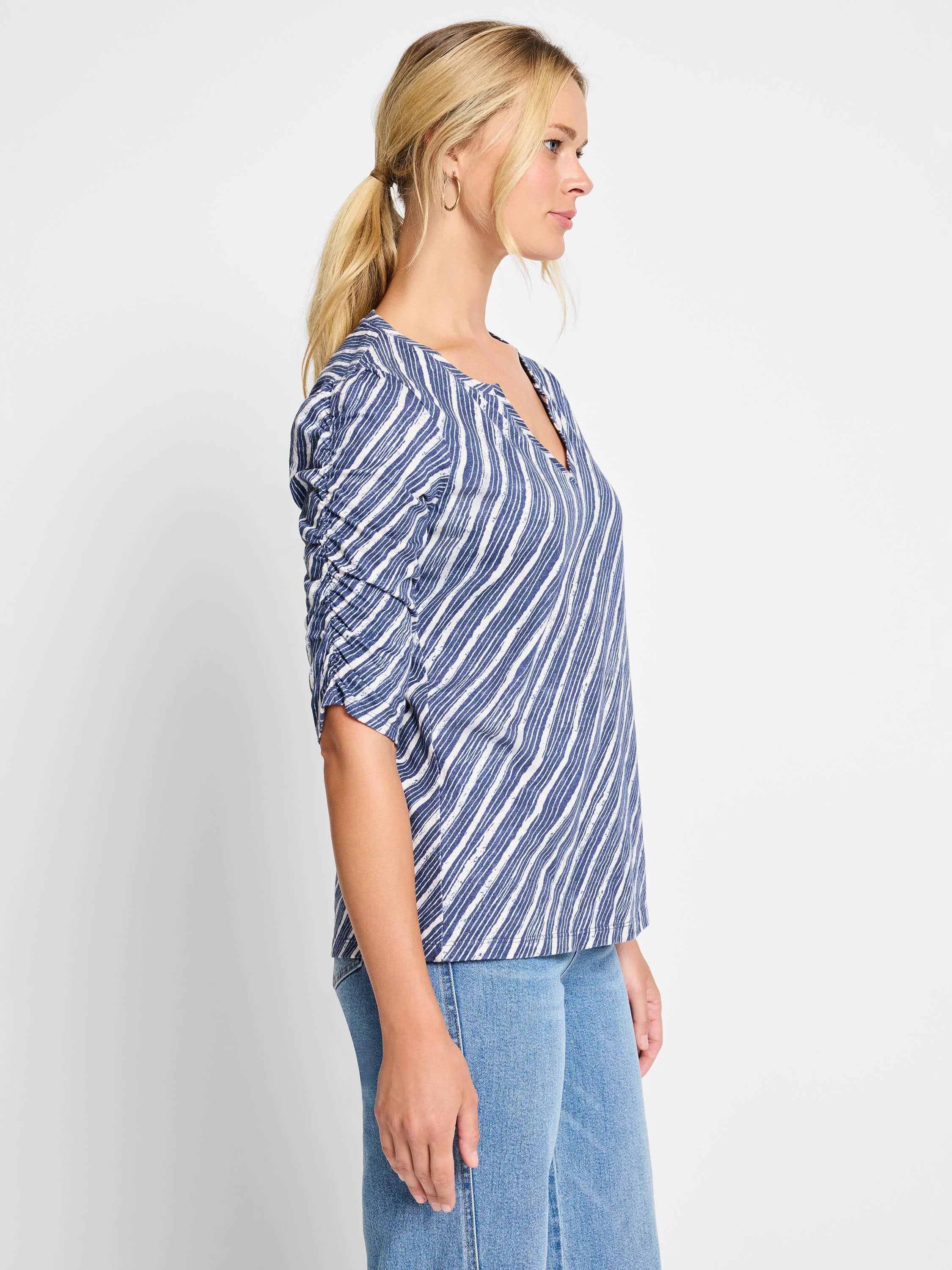 Image of a navy and white striped, 3/4 sleeve t-shirt with ruched sleeves and a slight V-neck.