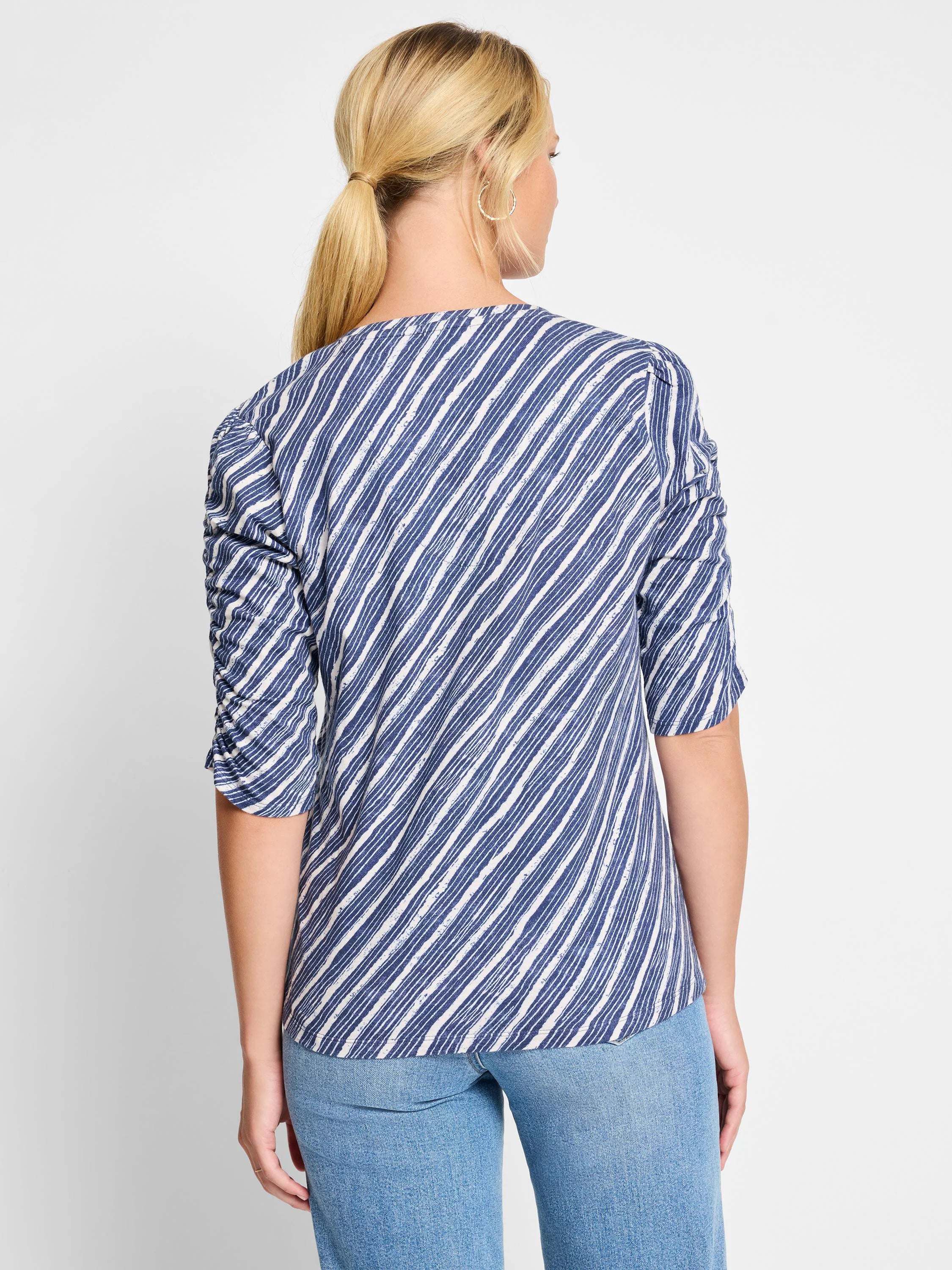 Image of a navy and white striped, 3/4 sleeve shirt.  The sleeves are ruched.