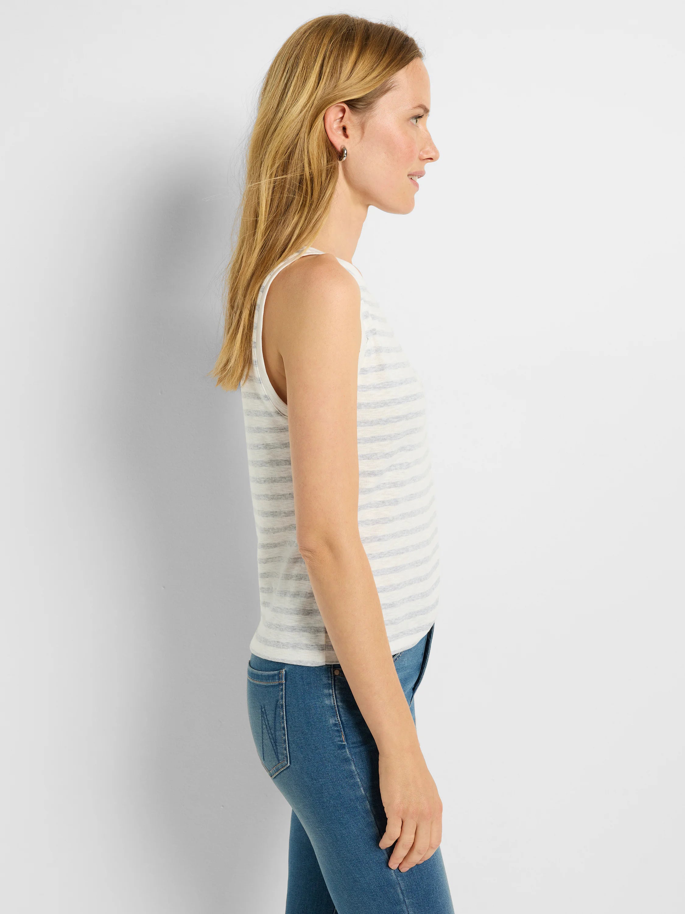 Off-white sleeveless tank top with thin, light blue horizontal stripes.