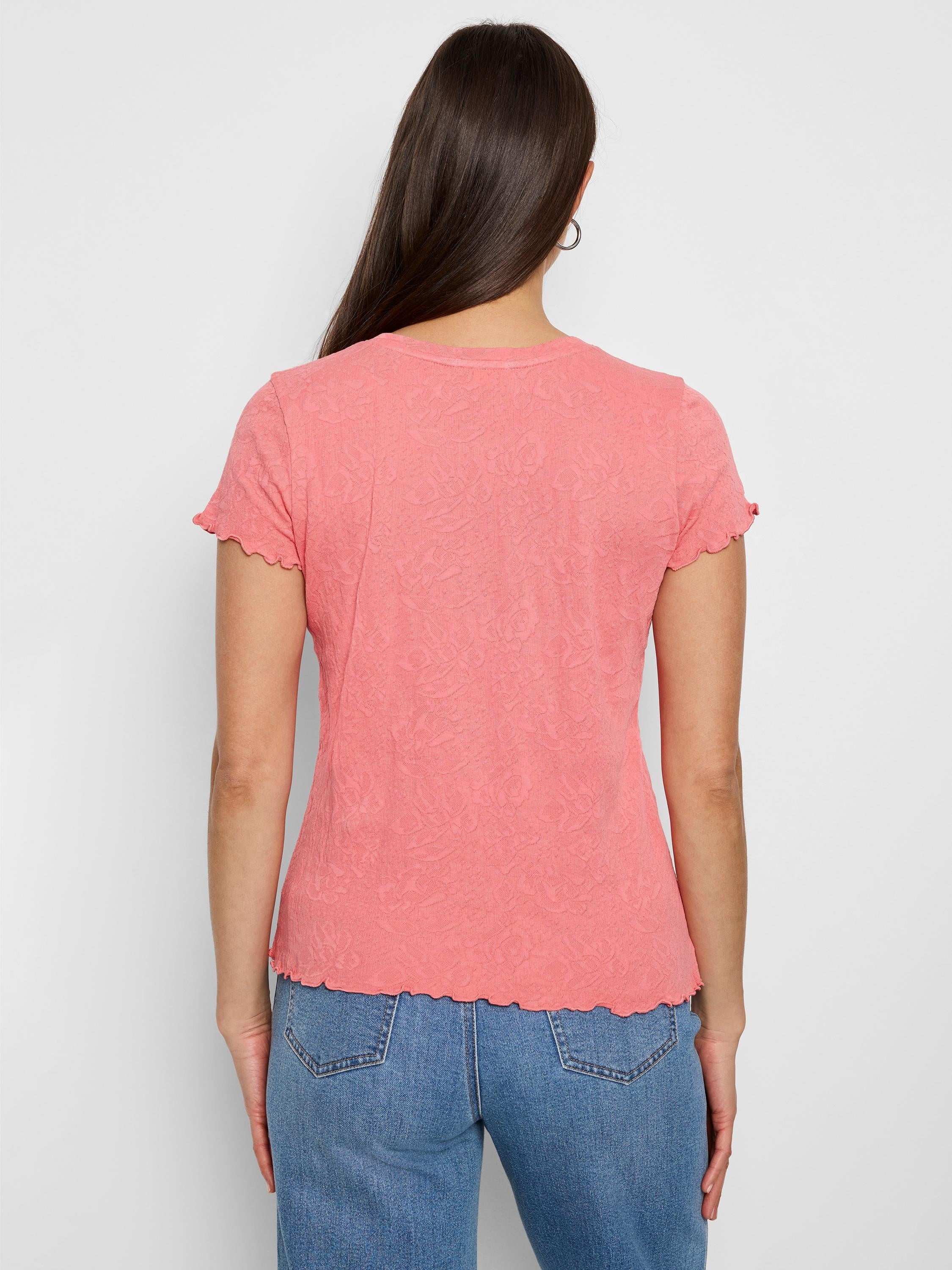 Coral pink, textured knit t-shirt. Short sleeves with scalloped edges, and a slightly scalloped hem.