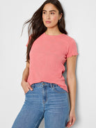 Coral pink, textured knit t-shirt with short, scalloped sleeves.