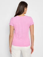 Pink short-sleeved shirt with textured lace knit and scalloped edges.