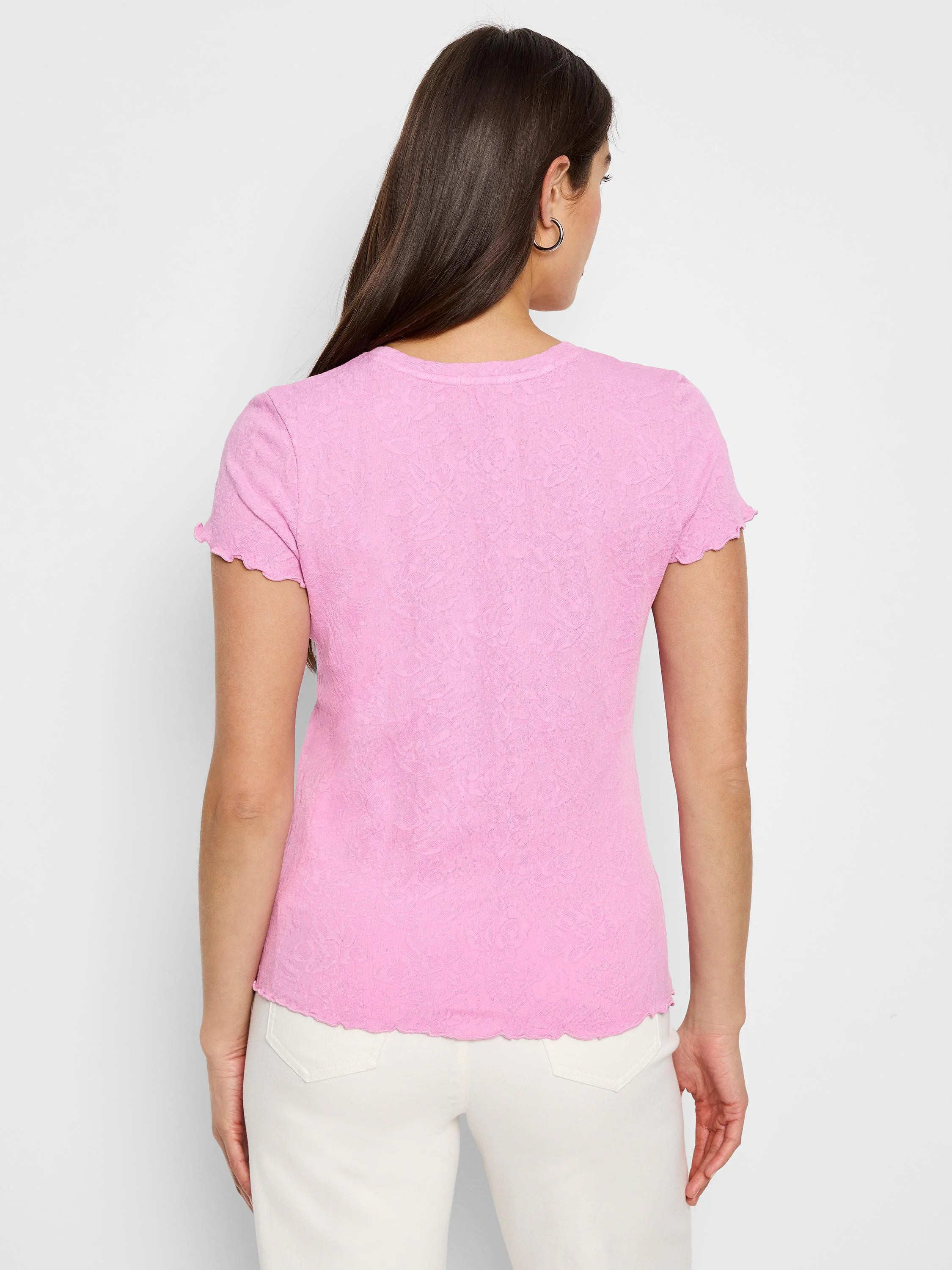 Pink short-sleeved shirt with textured lace knit and scalloped edges.