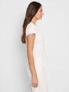 Off-white lace-knit t-shirt; short sleeves with scalloped edges;  textured fabric.