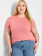 Coral pink short-sleeved t-shirt with textured, floral pattern and scalloped edges.