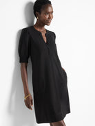 Black Henley dress, short sleeves with slight puff, V-neckline, and side pockets.
