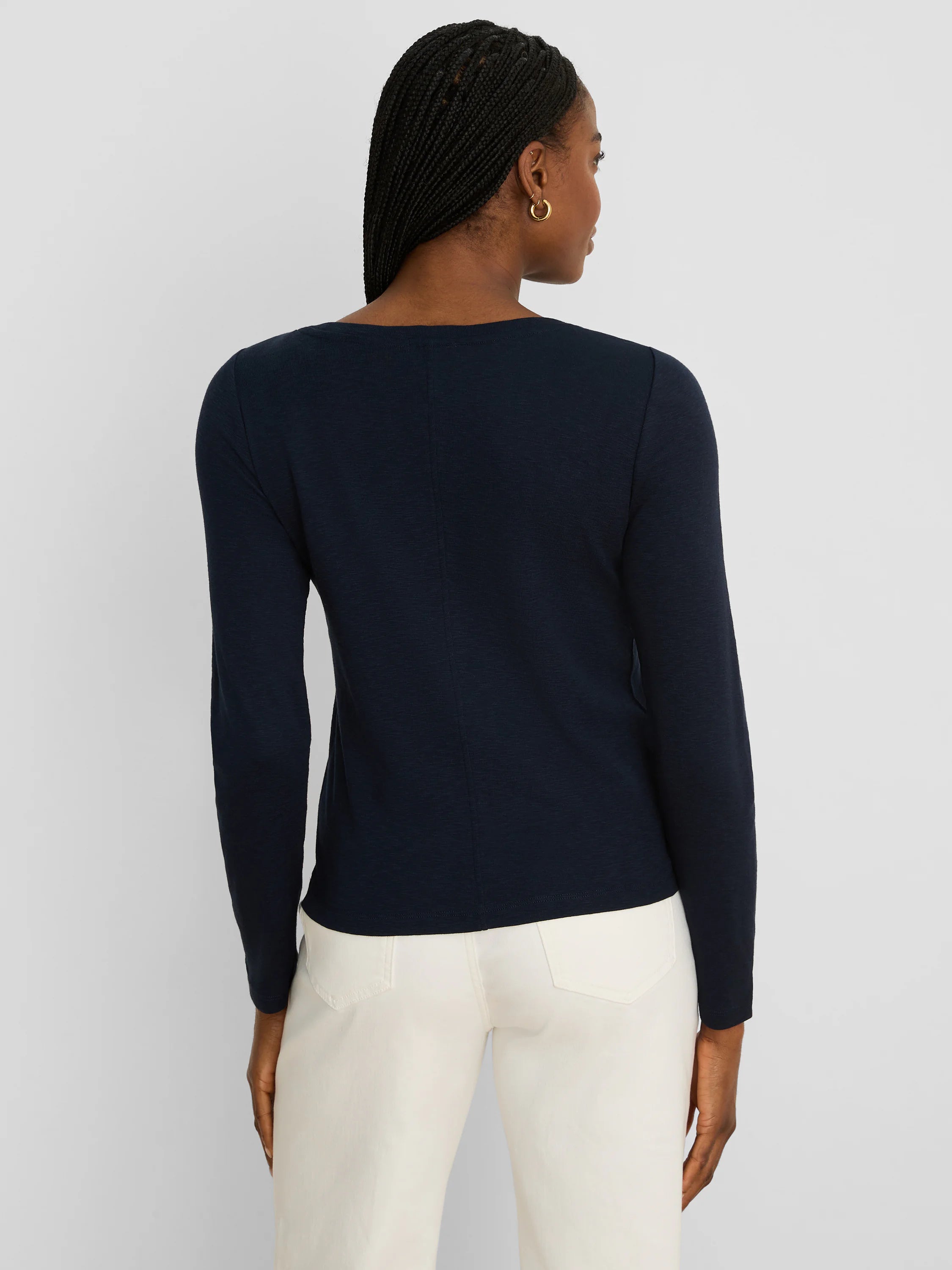 Dark blue ribbed long-sleeve boat neck tee with a center back seam, shown on a model from behind.
